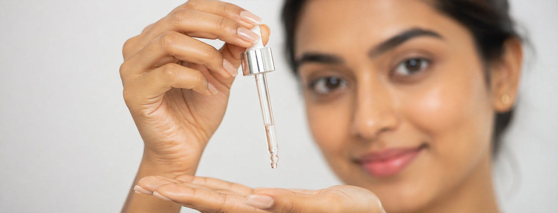 Woman applying serum for oily skin in Bangladesh